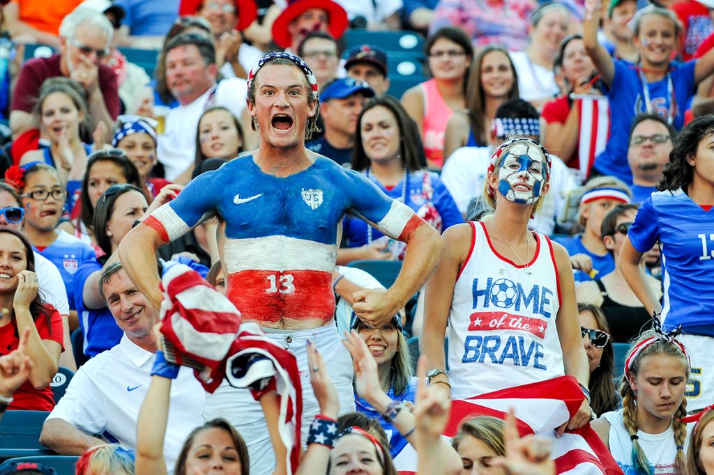 American soccer fans cheer for Team USA during a game.